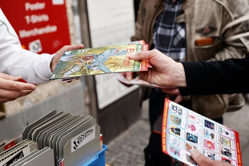 Ein Mitarbeiter sucht für Interessenten vor einer Comic-Buchhandlung Comic-Hefte heraus (Symbolbild): Ziel der Aktion ist es, den stationären Buchhandel gegenüber der Online-Konkurrenz zu stärken.