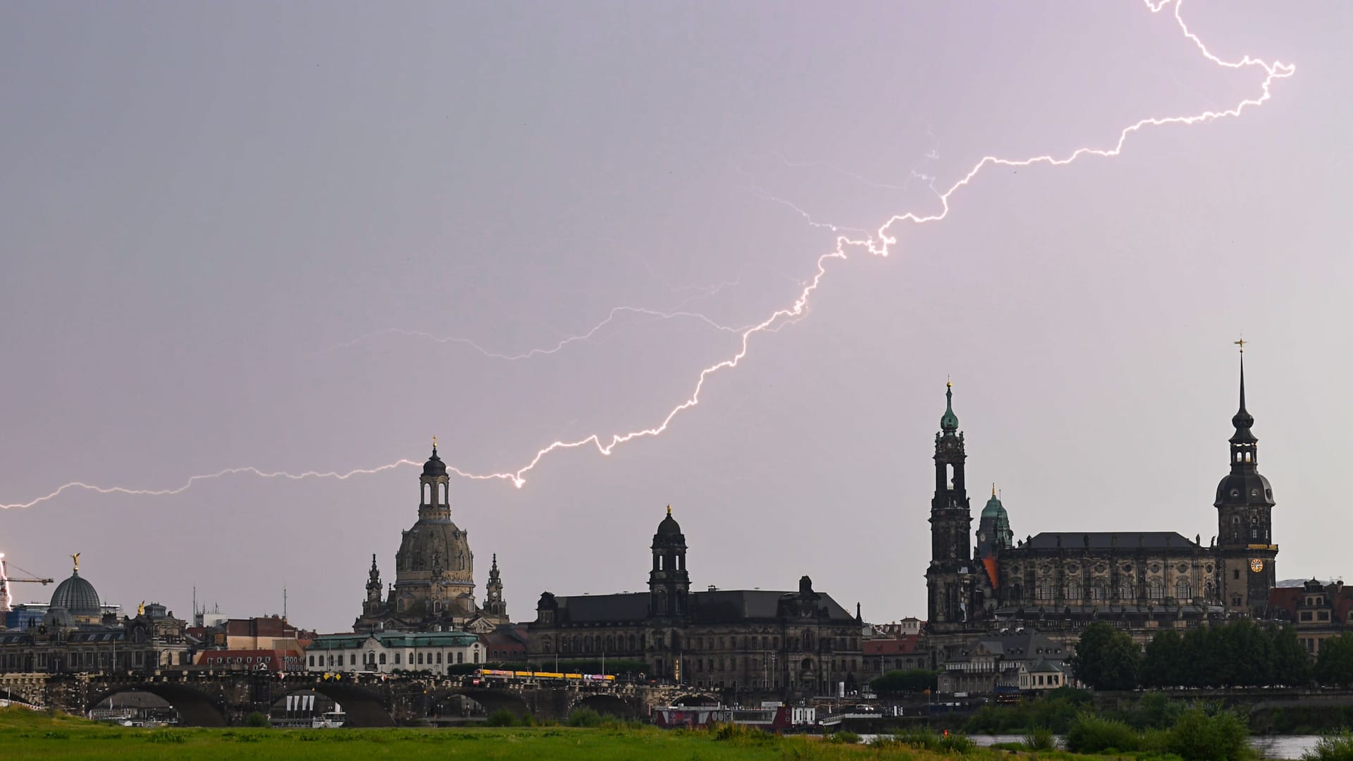 Blitze am Himmel über der Altstadt Dresdens (Archivbild): Dank Gewittern und Regenschauern am Wochenende kühlten die Temperaturen in Sachsen ab.
