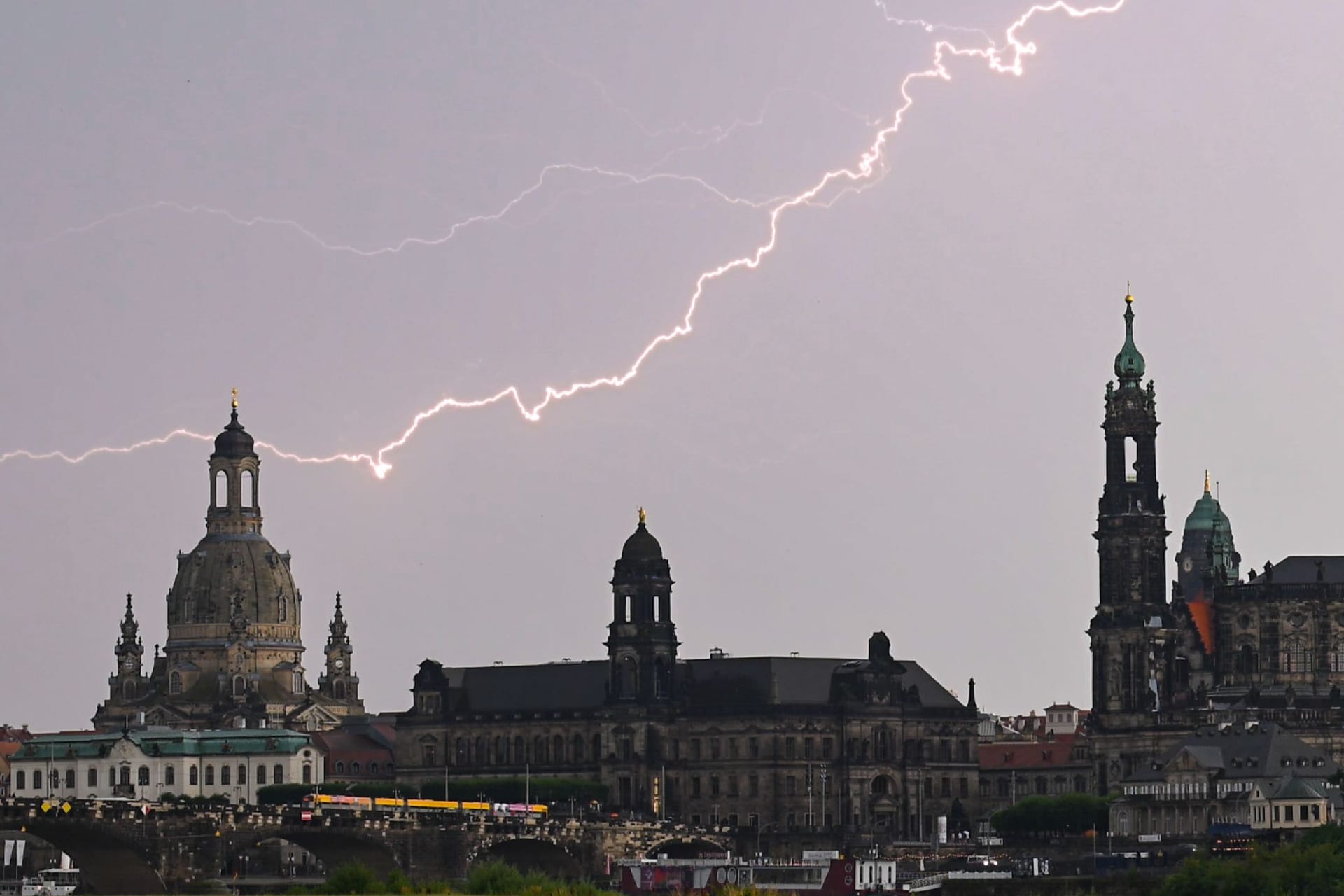 Blitze am Himmel über der Altstadt Dresdens (Archivbild): Dank Gewittern und Regenschauern am Wochenende kühlten die Temperaturen in Sachsen ab.