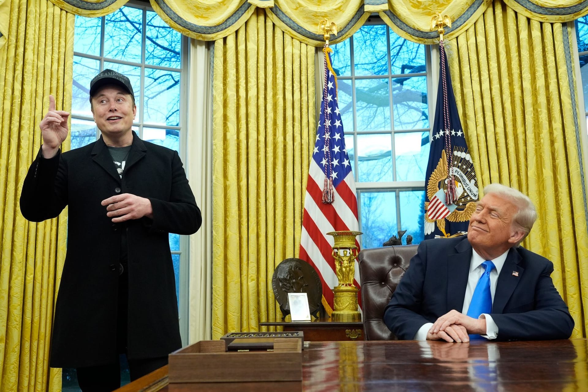 US-Präsident Donald Trump (r) hört zu, als Elon Musk im Oval Office im Weißen Haus spricht.