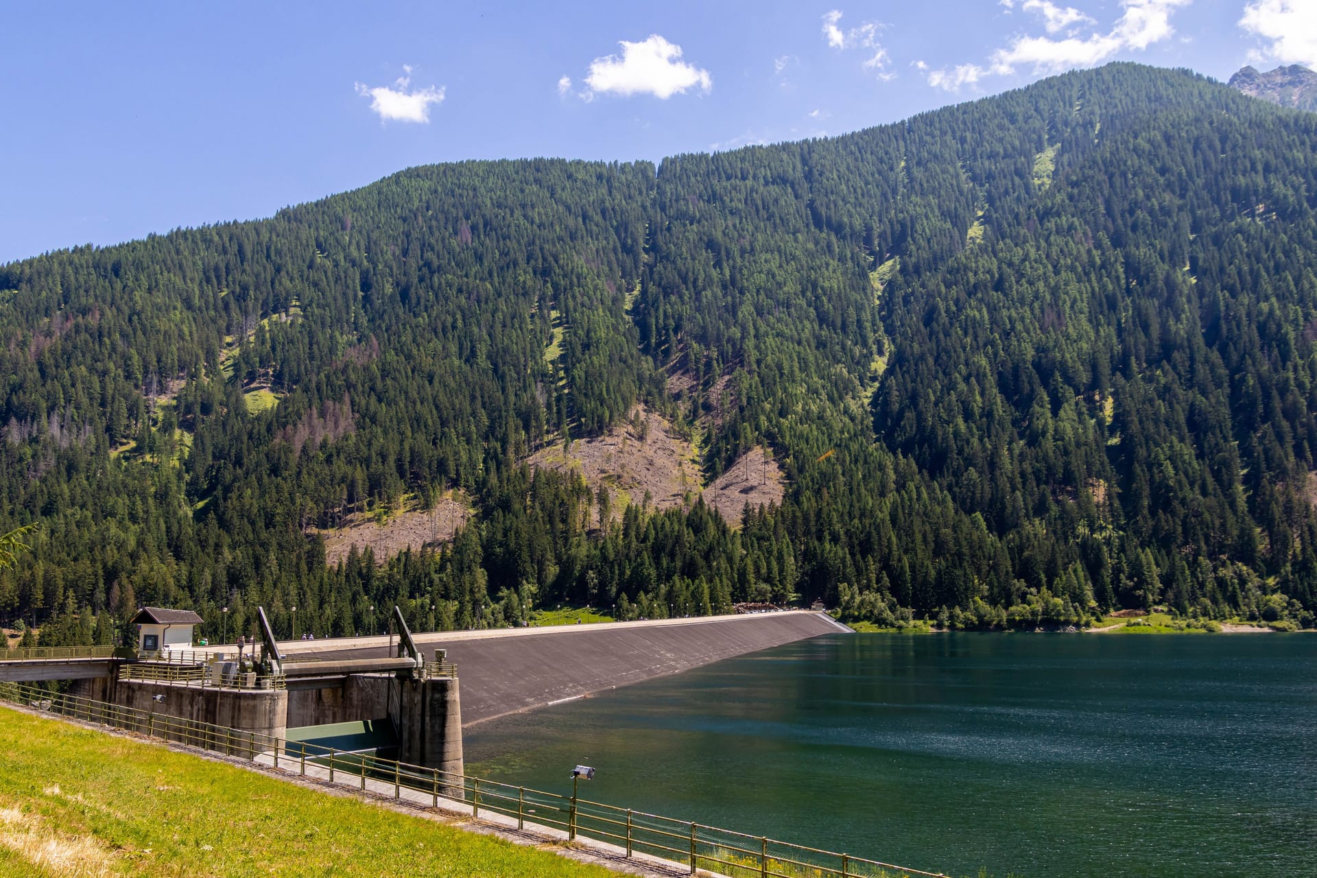 Artificial alpine reservoir lake Zoccolo and mountain range at Ultental, South Tyrol Italy