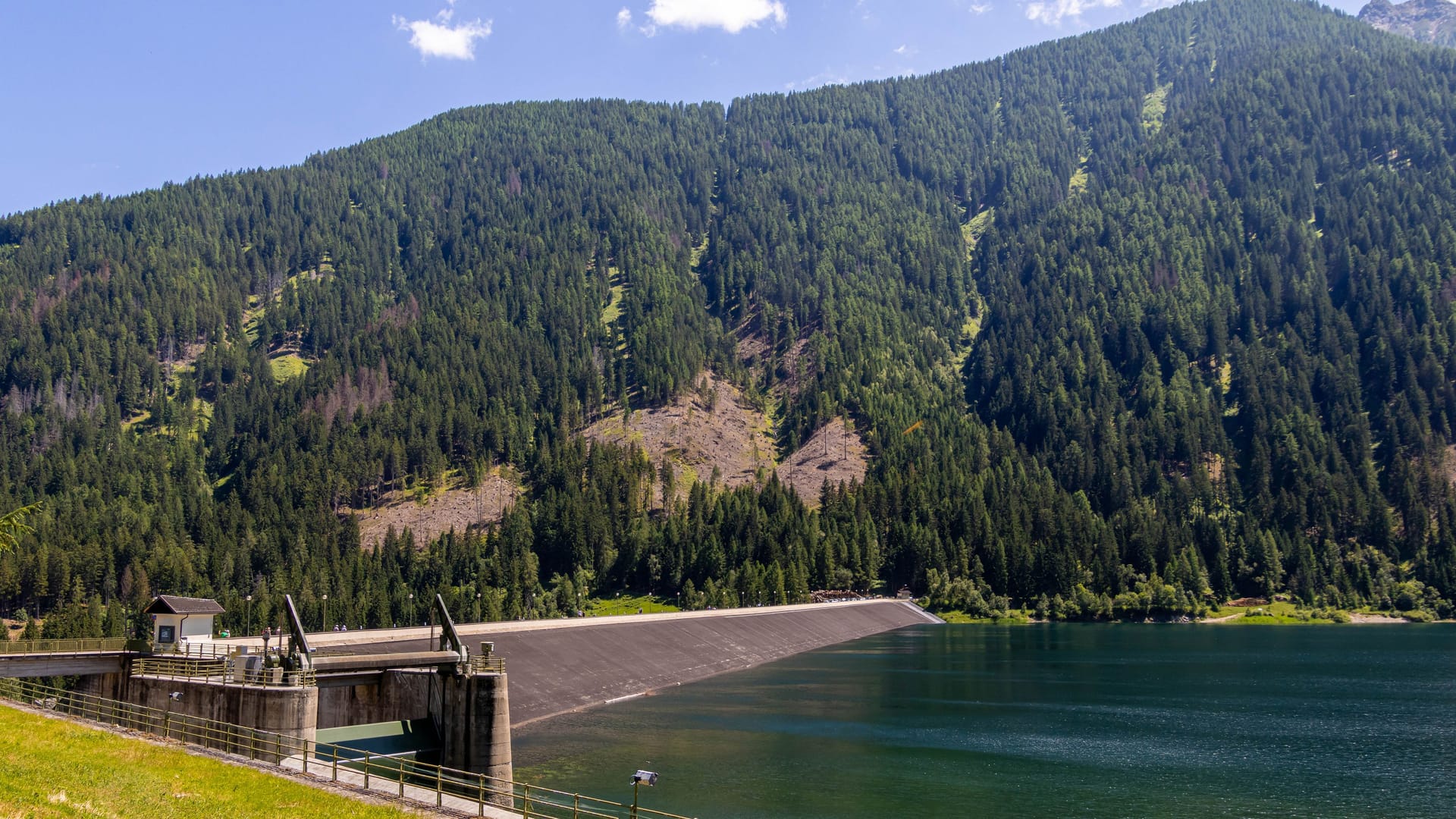 Artificial alpine reservoir lake Zoccolo and mountain range at Ultental, South Tyrol Italy