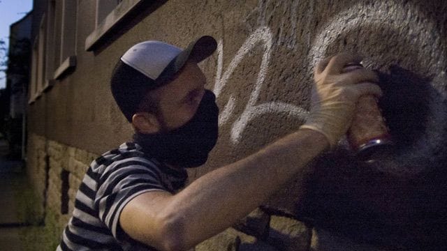 Ein Sprayer (Symbolbild): Unbekannte haben Gebäude der RWTH mit Graffitis besprüht.
