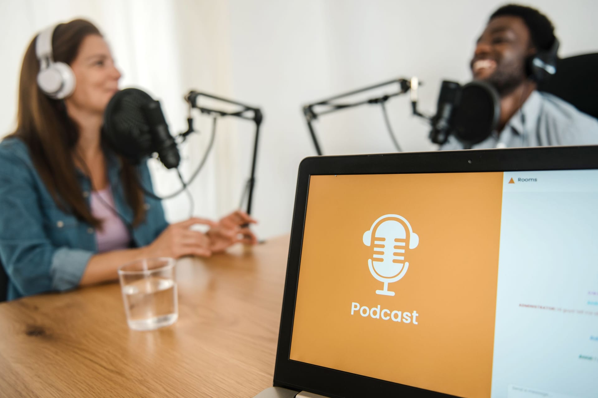 Laptop against diverse colleagues recording podcast