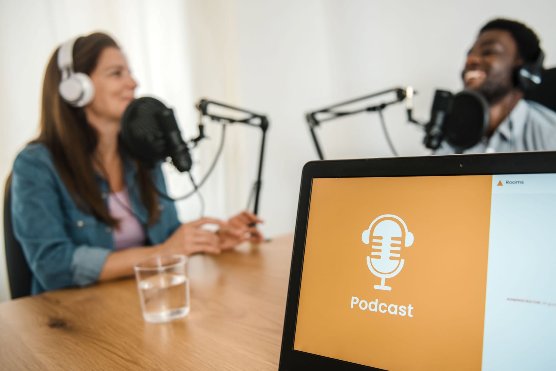 Laptop against diverse colleagues recording podcast