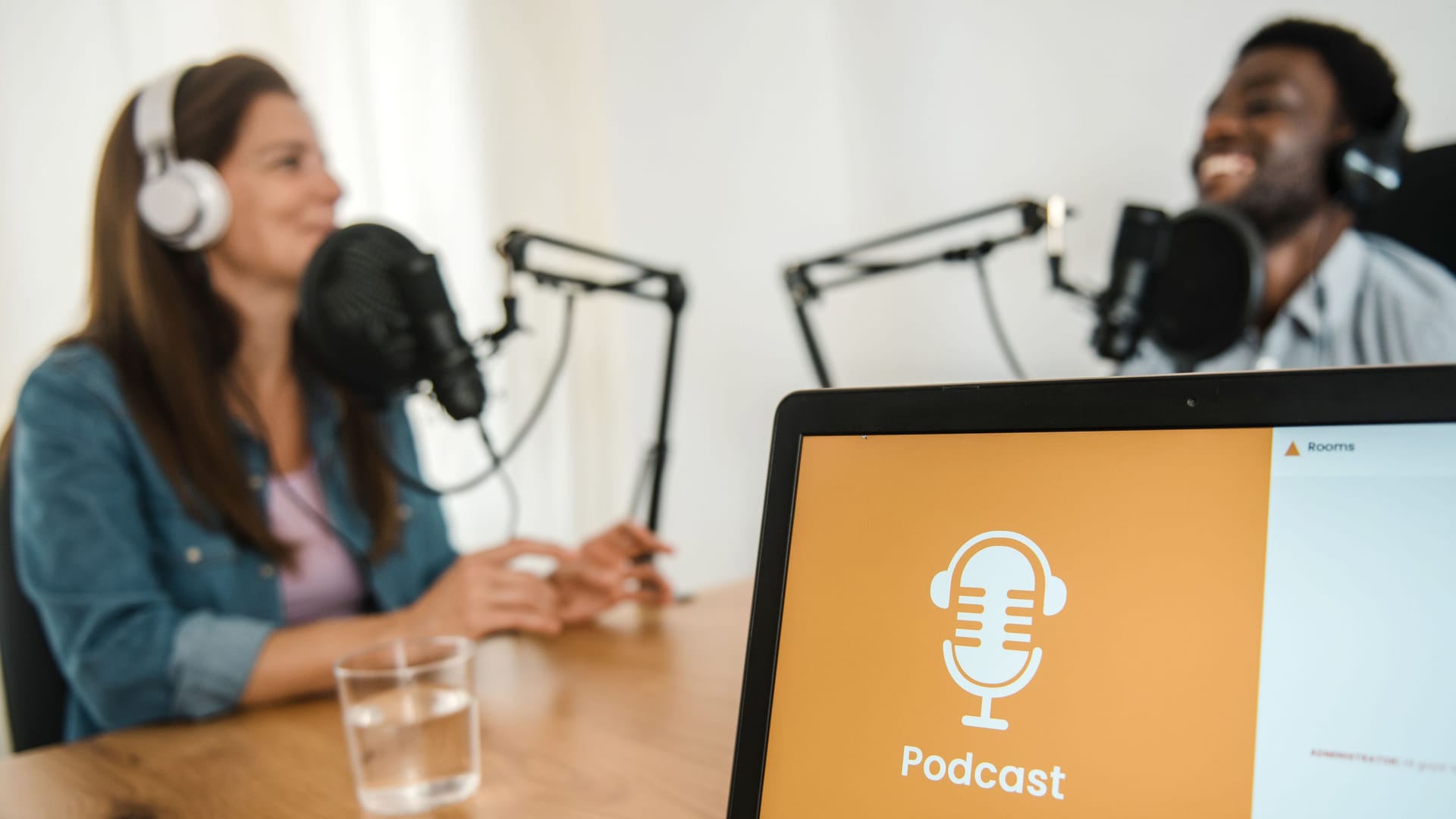 Laptop against diverse colleagues recording podcast