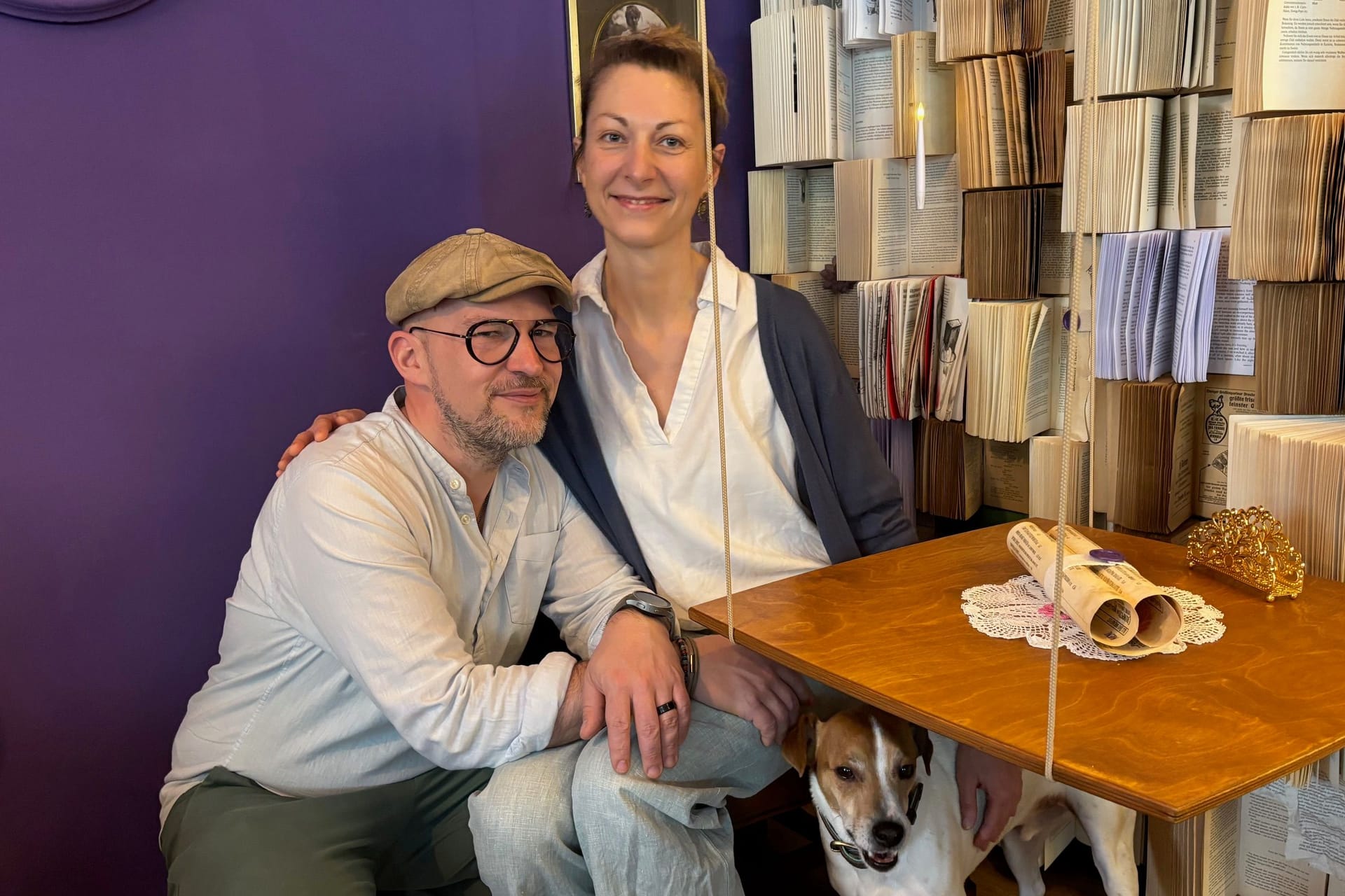 Sarah Hillebrand, Betreiberin des Cafés, und ihr Partner Benedikt Faust: Die beiden sitzen an einem ihrer schwebenden Tische vor der Bücherwand.