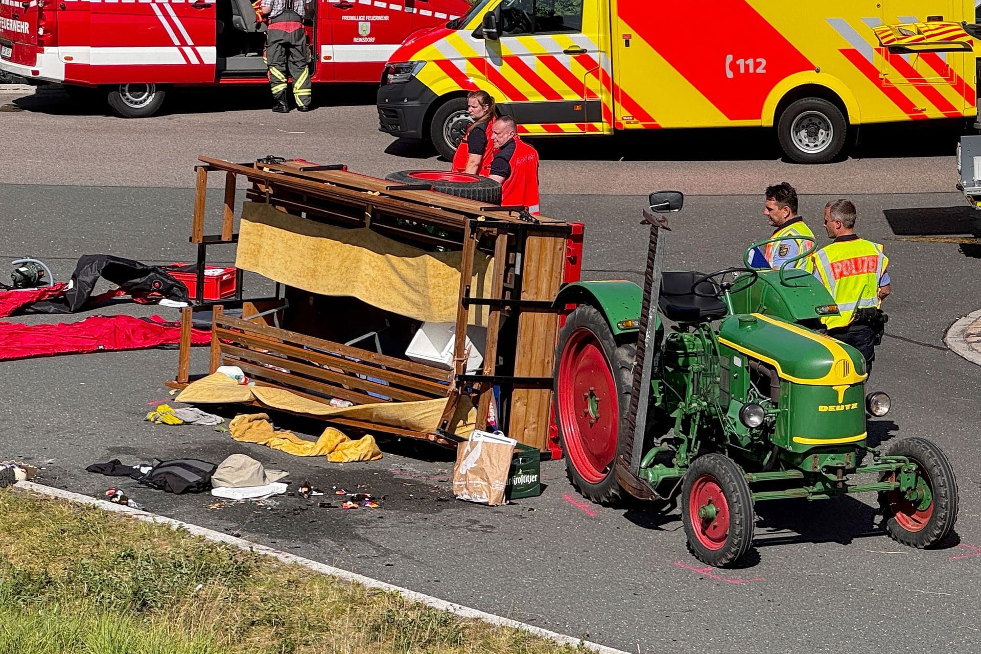 Ein Kutschenanhänger liegt umgekippt auf einer Straße. Bei dem Unfall mit einer Ausflugskutsche sind in Reinsdorf bei Zwickau elf Menschen verletzt worden. Ein Kutschenanhänger liegt umgekippt auf einer Straße. Bei dem Unfall mit einer Ausflugskutsche sind in Reinsdorf bei Zwickau elf Menschen verletzt worden.
