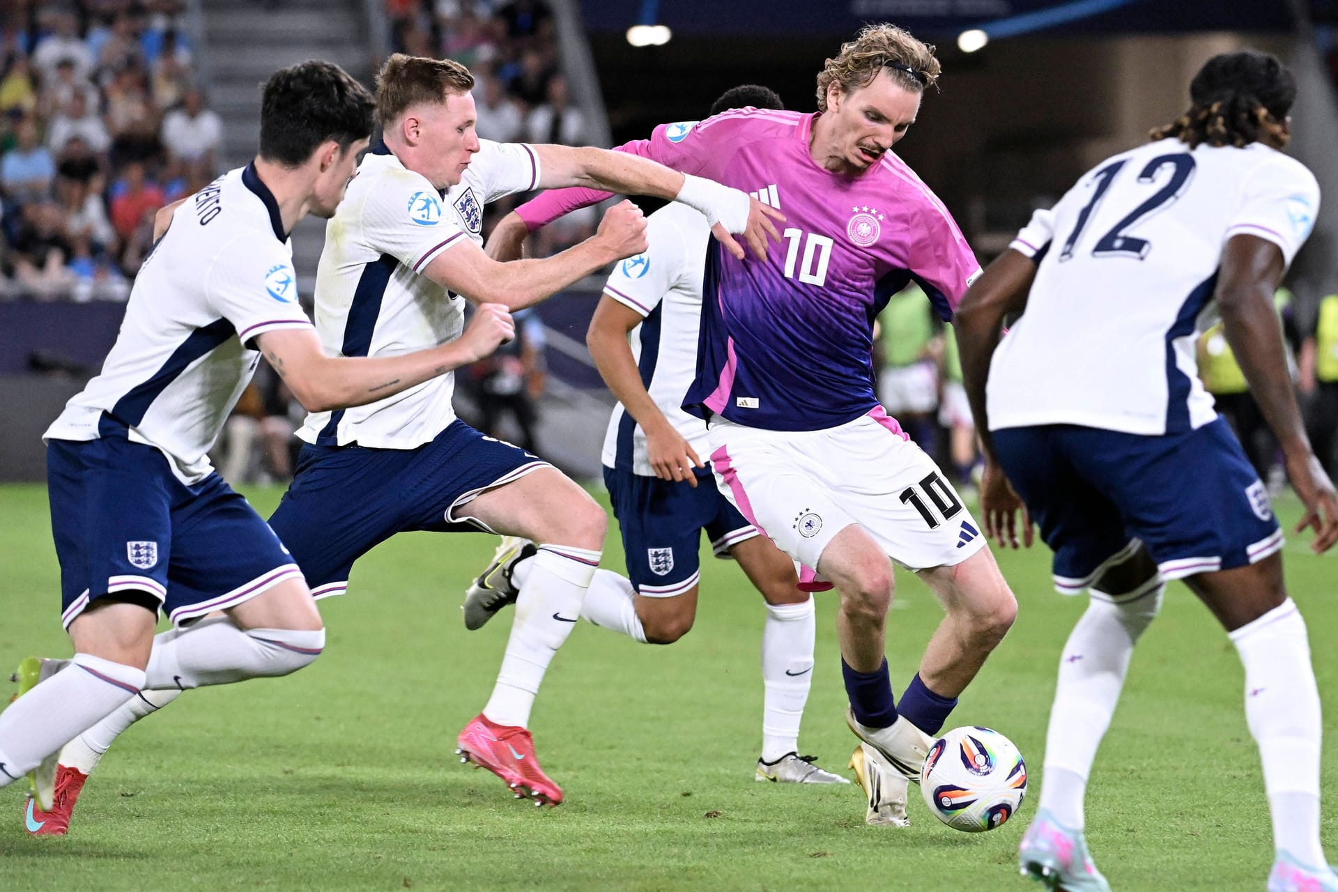 Deutschlands Woltemade (M.) umringt von englischen Gegenspielern: Das Finale der U21-EM ging in die Verlängerung. Deutschlands Woltemade (M.) umringt von englischen Gegenspielern: Das Finale der U21-EM ging in die Verlängerung.