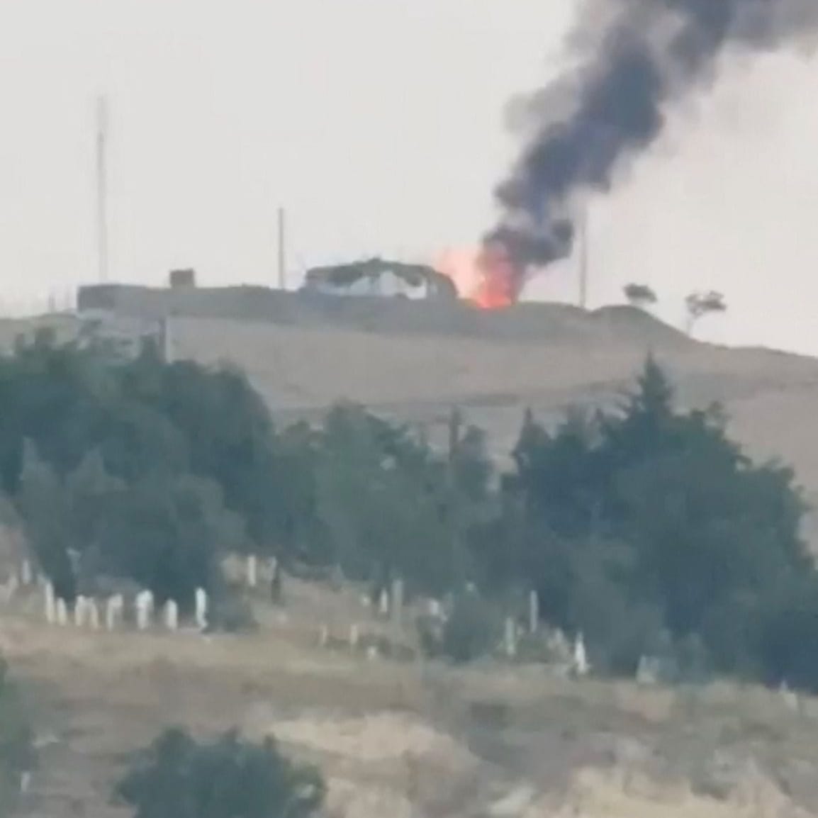 Smoke and flames rise, following Israeli strikes on Iran, in Piranshahr