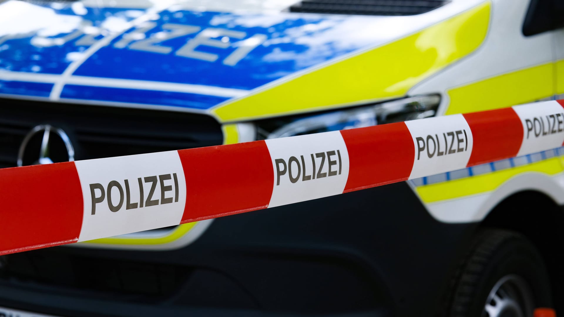 Absperrband vor Polizeifahrzeug: Verdächtiges Pulver löst Großeinsatz im DHL-Zentrum aus.