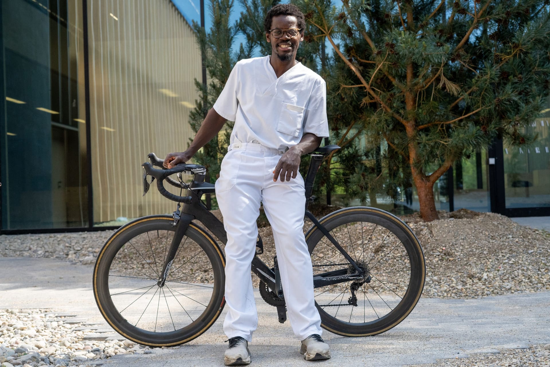 Emmanuel Adjei mit seinem Fahrrad auf dem Campus für Präventive Sportmedizin der TU München (TUM) am Olympiapark.