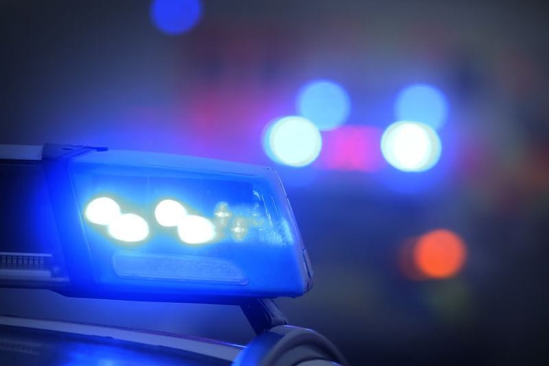 Ein Polizeiauto mit eingeschaltetem Blaulicht (Symbolbild): Alle drei Personen erlitten Verletzungen.