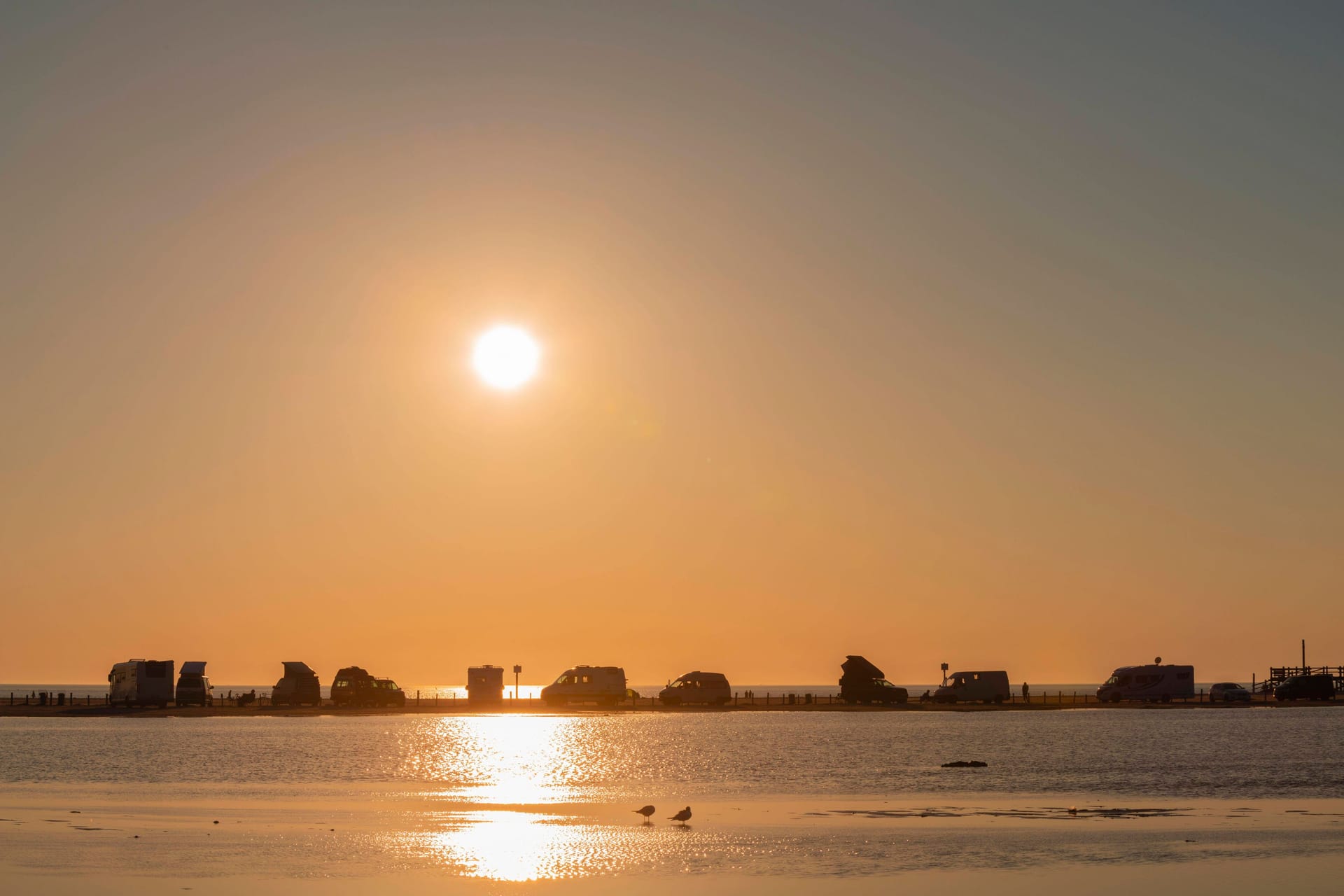 Camper am Strand St. Peter Ording im Sonnenuntergang (Archivbild): An der Nordsee gibt es einige Campingplätze, an denen Camper ganz nah am Meer schlafen können.