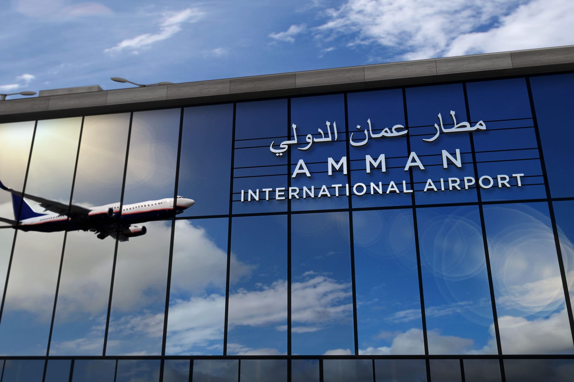 Airplane landing at Amman Jordan airport mirrored in terminal