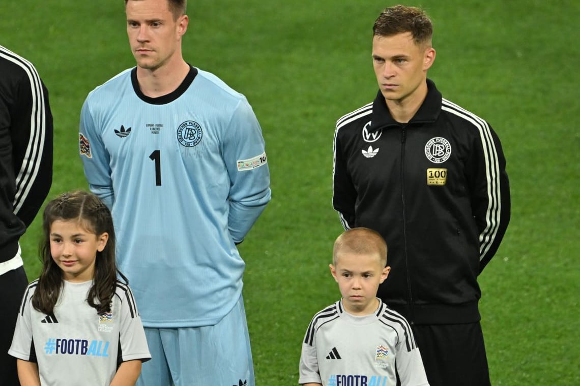 Mit "100"-Aufnäher auf der Trainingsjacke: Joshua Kimmich und einer seiner Söhne vor Anpfiff der Partie gegen Portugal.
