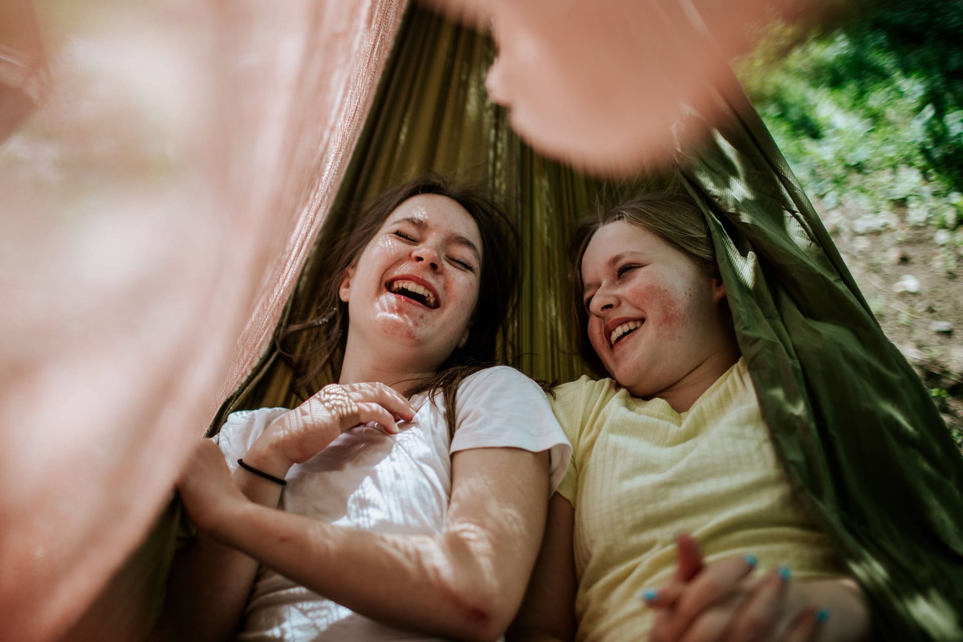 Glücklich: Mädchen liegen gemeinsam in einer Hängematte. Auf einem Campingplatz finden Kinder schnell Freunde.