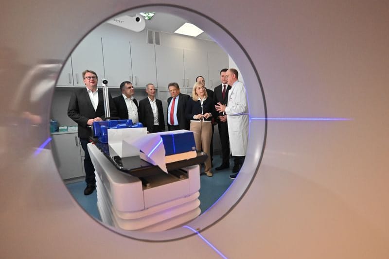 Blick durch einen einen Ethos-Linearbeschleuniger: Wolfgang Hoffmann (r.), Direktor der Klinik für Strahlentherpie, erklärt Nina Warken (CDU), Bundesgesundheitsministerin, und Andreas Philippi (SPD, 5.v.r.), Gesundheitsminister Niedersachsen, die Funktion.