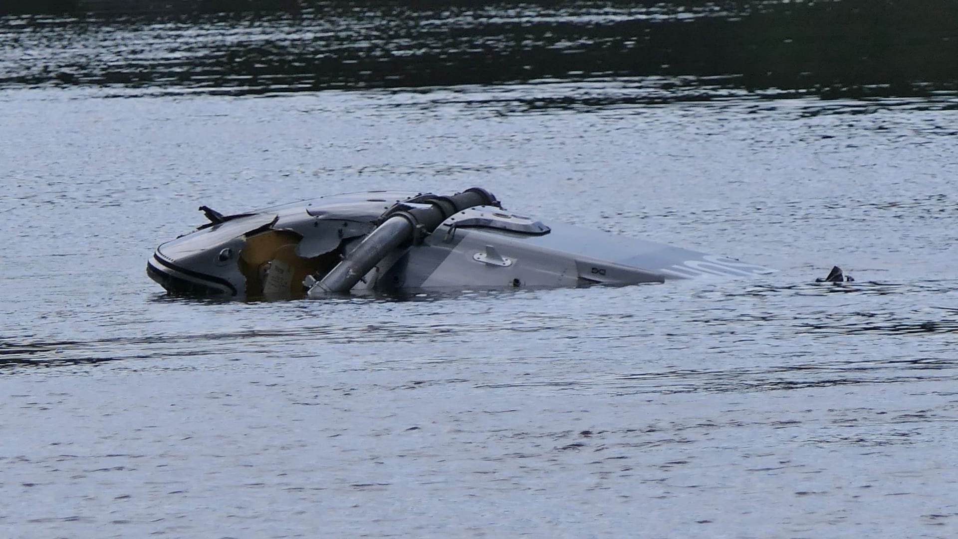 Ein Hubschrauberg der Bundeswehr treibt in der Nähe von Grimma in Sachsen in einem Fluss.