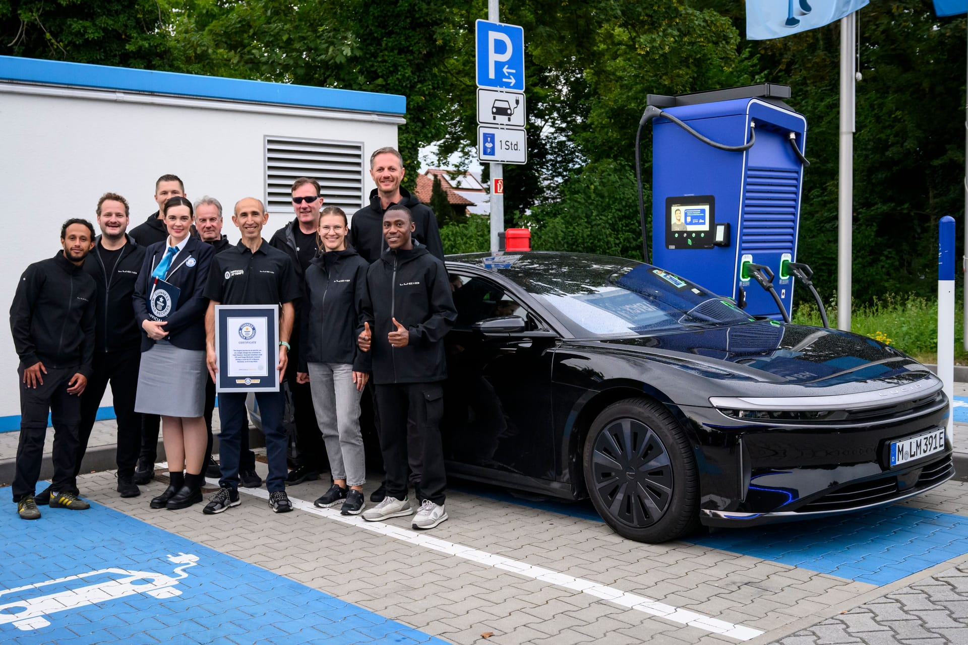 Das Team rund um die Weltrekordfahrt vereint am Ziel: Nach über 1.200 Kilometern ohne Ladestopp wird der Erfolg offiziell von Guinness World Records bestätigt.