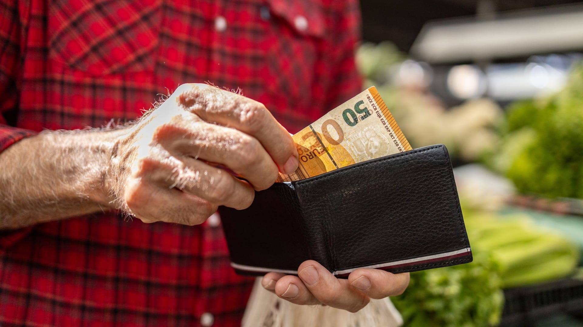 Älterer Mann zieht 50 Euro aus dem Geldbeutel: Die Rentendebatte kreist vor allem um die Frage, was es kosten darf. Älterer Mann zieht 50 Euro aus dem Geldbeutel: Die Rentendebatte kreist vor allem um die Frage, was es kosten darf.