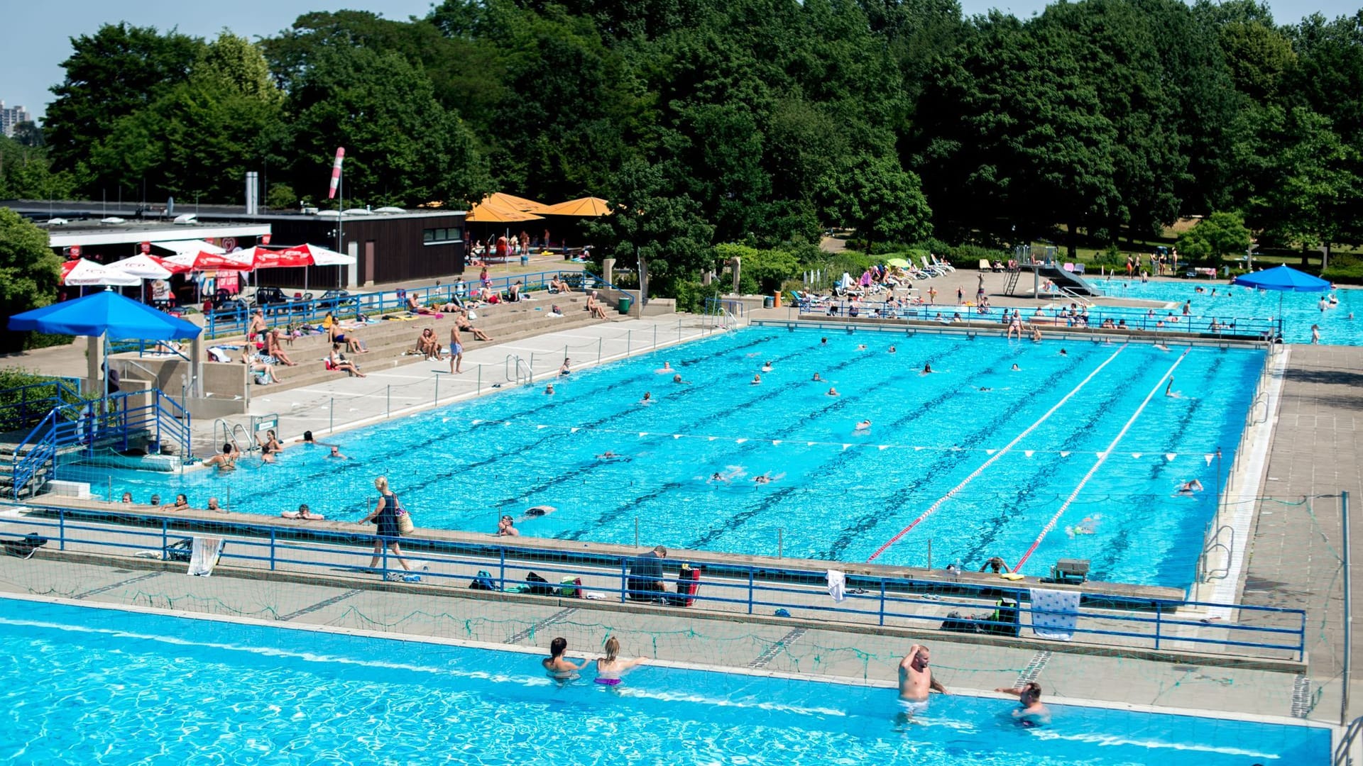 Menschen schwimmen in mehreren Becken im Lister Freibad (Archivbild): So viel ist aktuell in den Freibädern nicht los. Menschen schwimmen in mehreren Becken im Lister Freibad (Archivbild): So viel ist aktuell in den Freibädern nicht los.