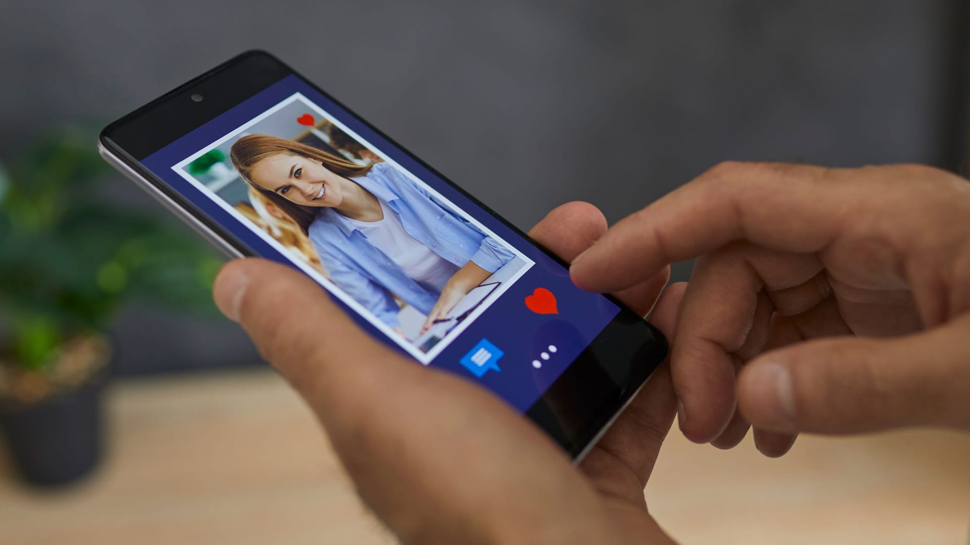 Man flipping through profiles in dating app presses red heart as a sign of sympathy for girl. Man flipping through profiles in dating app presses red heart as a sign of sympathy for girl.