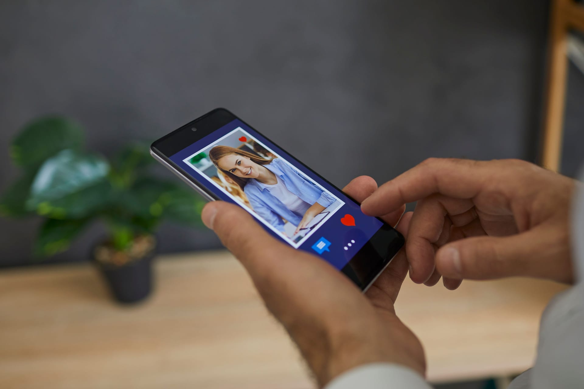 Man flipping through profiles in dating app presses red heart as a sign of sympathy for girl.