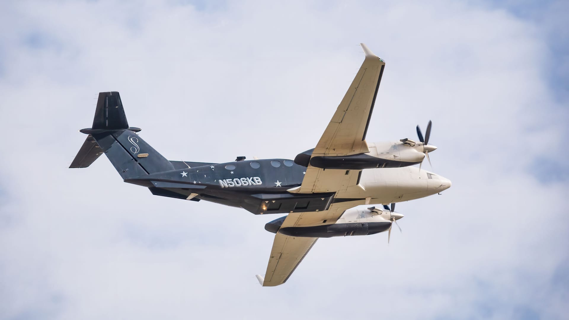 Bucharest, Romania - August 2022:Beechcraft B300 King Air 350 twin-turboprop aircraft flying against blue sky Bucharest, Romania - August 2022:Beechcraft B300 King Air 350 twin-turboprop aircraft flying against blue sky