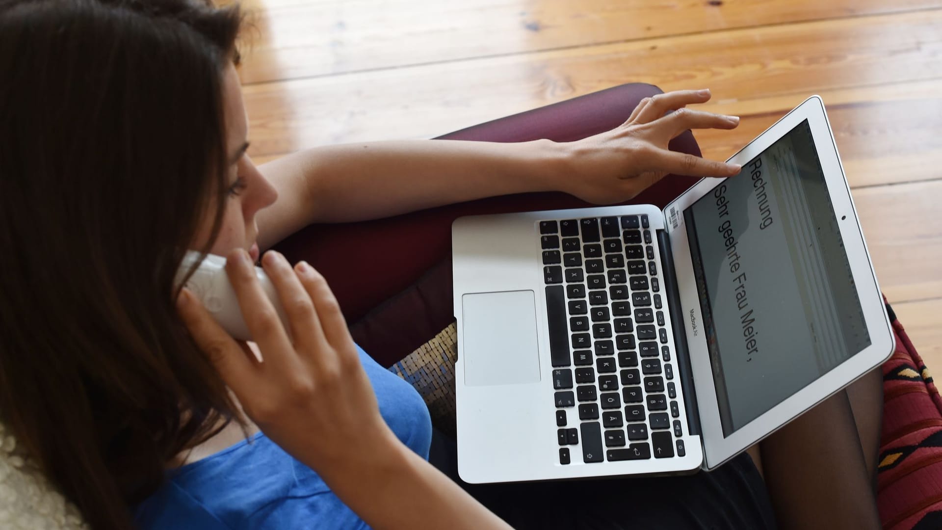Frau mit Laptop telefoniert Frau mit Laptop telefoniert