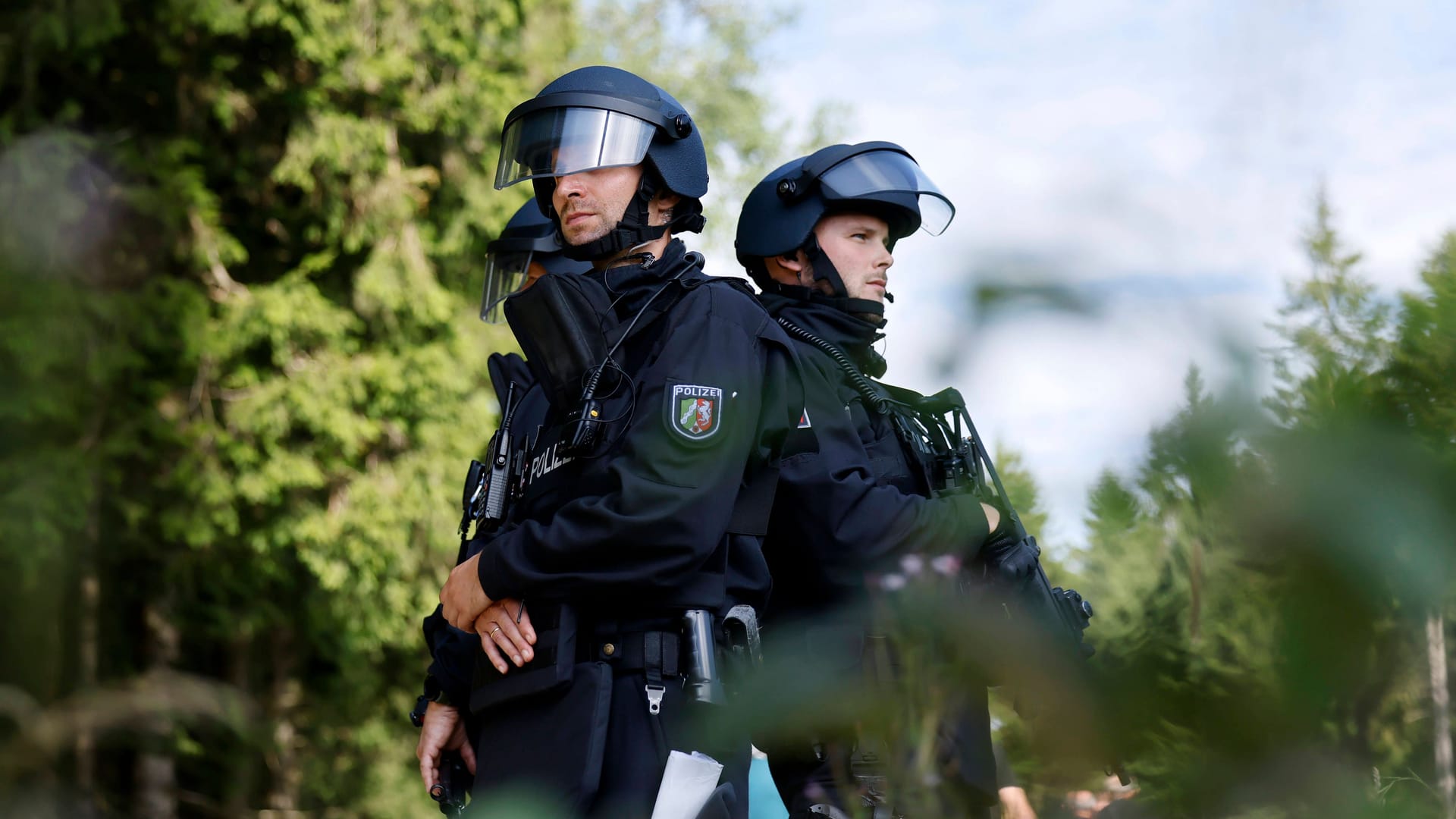 Polizisten in einem Wald (Symbolfoto): Nach einem Vorfall in einem Waldstück in Leverkusen-Alkenrath ermittelt die Polizei.