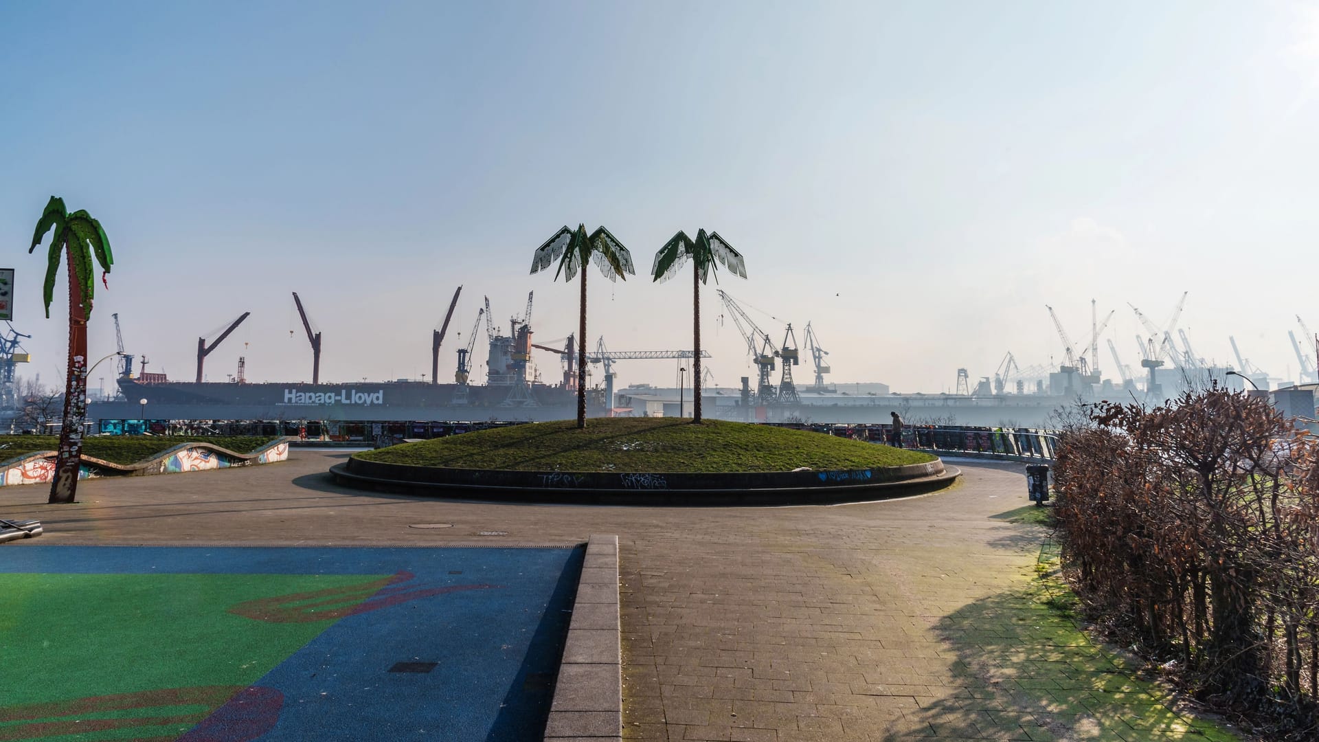 Park Fiction area in Hamburg Sankt Pauli with harbor in background under blue sky Park Fiction area in Hamburg Sankt Pauli with harbor in background under blue sky