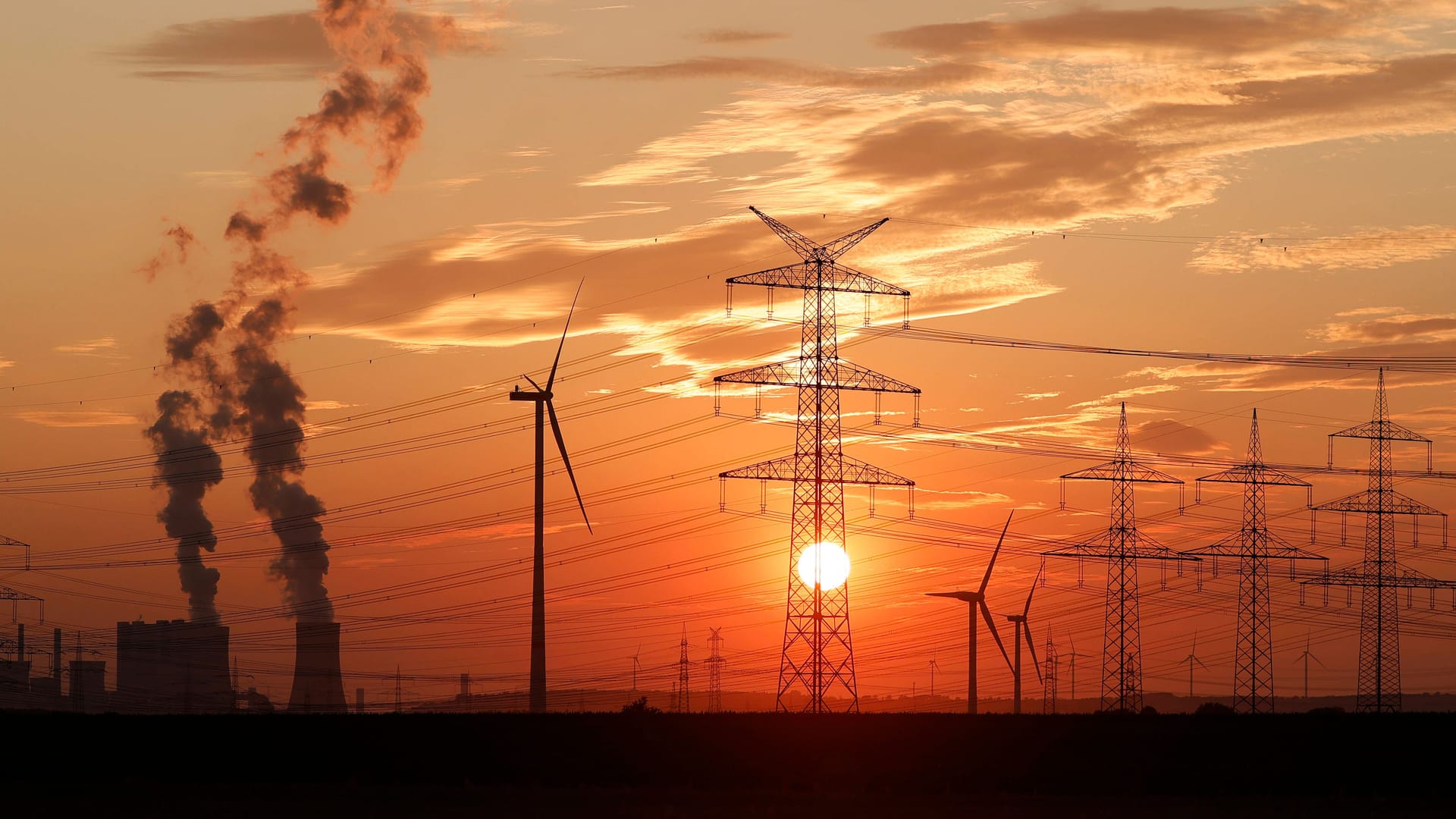 Strommasten und Windräder rund um das Kohlekraftwerk Niederaußem des Stromkonzerns RWE (Symbolbild).