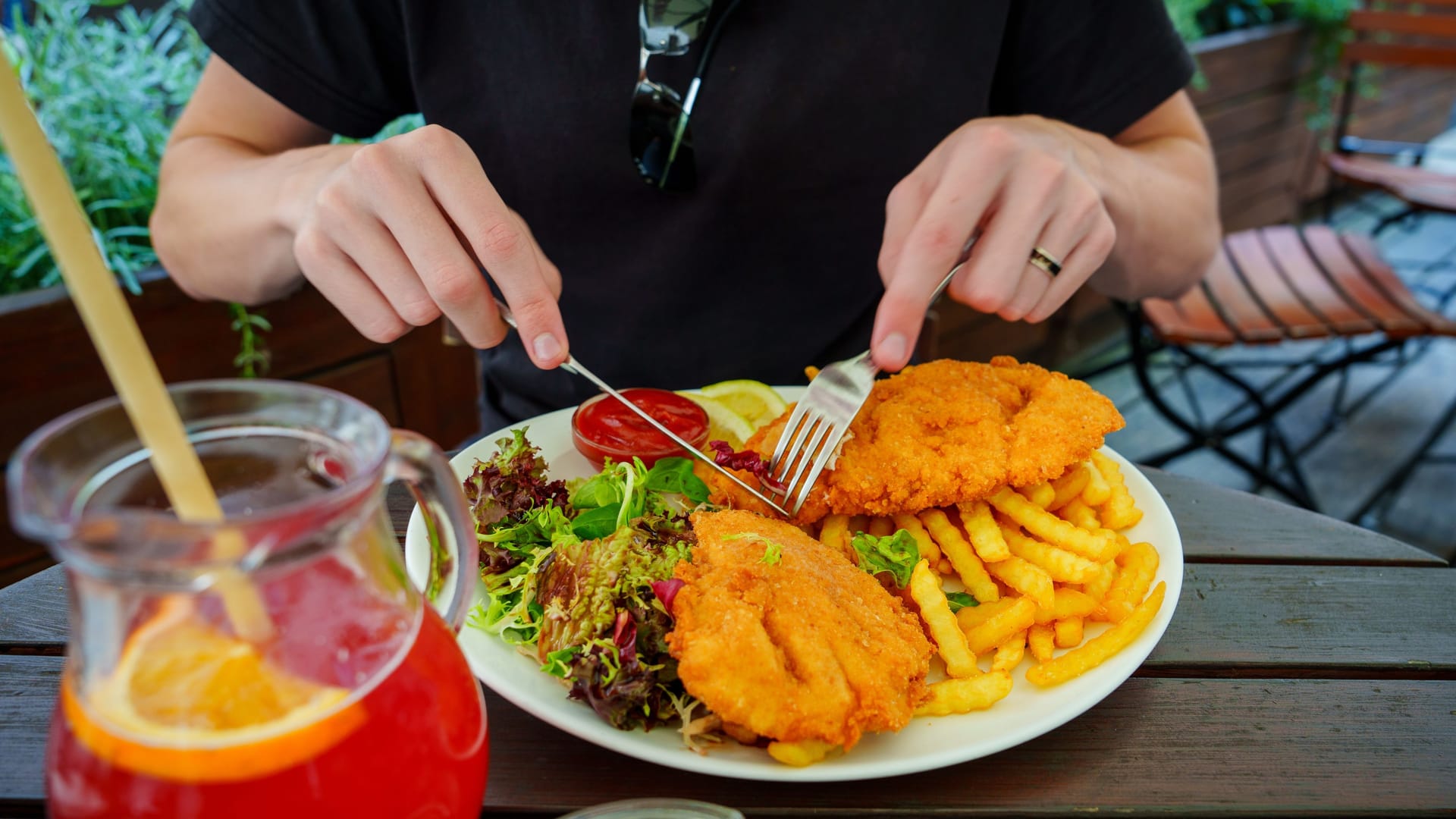 Delicious Crispy Breaded Chicken Schnitzel Served with Fresh Salad and Golden French Fries
